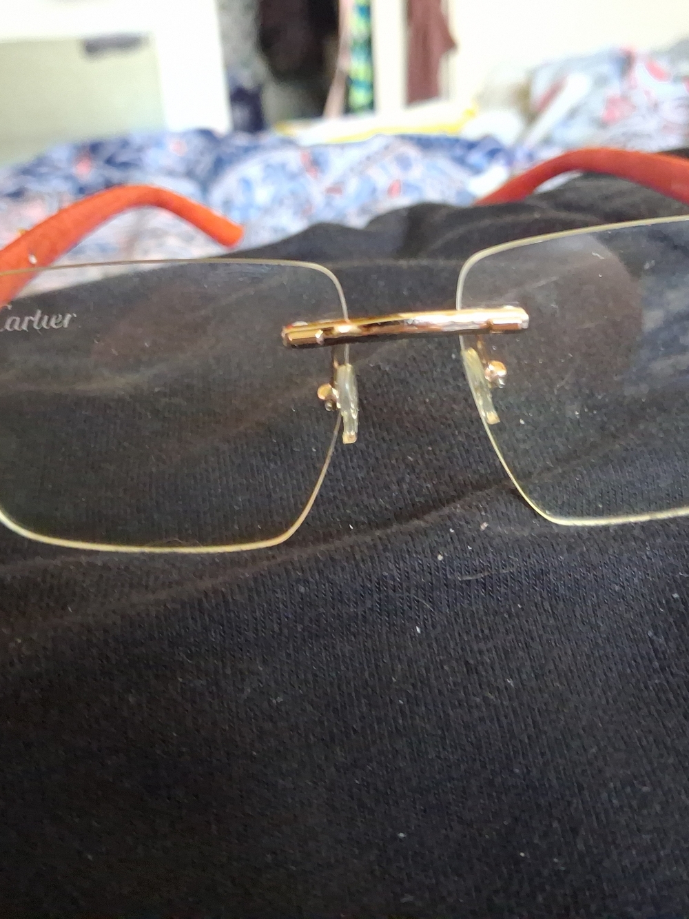 Cartier Men’s Rimless Glasses with Gold Bridge and Orange Temples
